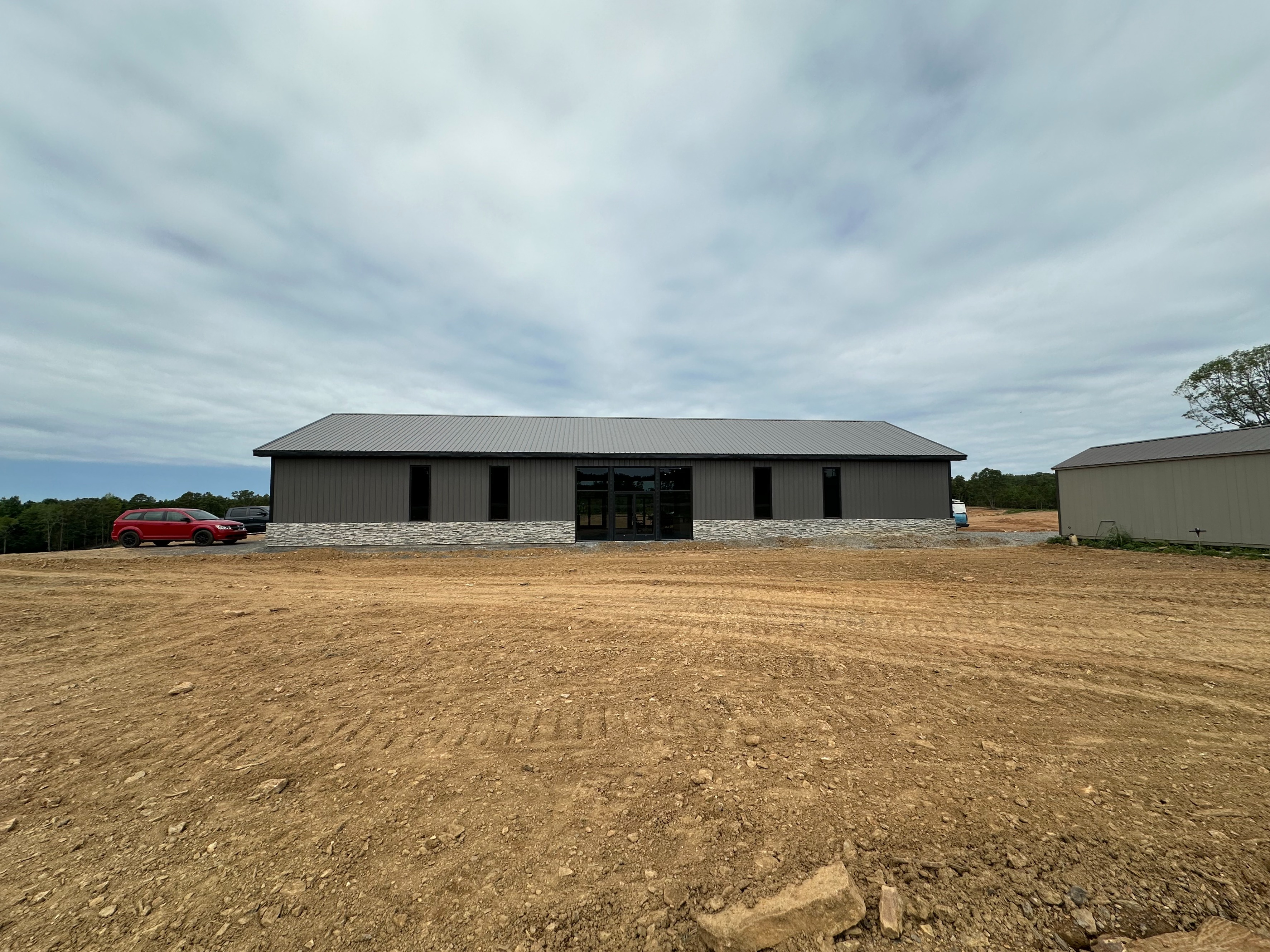 HEO Academy training facility with the original 300-square-foot classroom still visible beside the current building