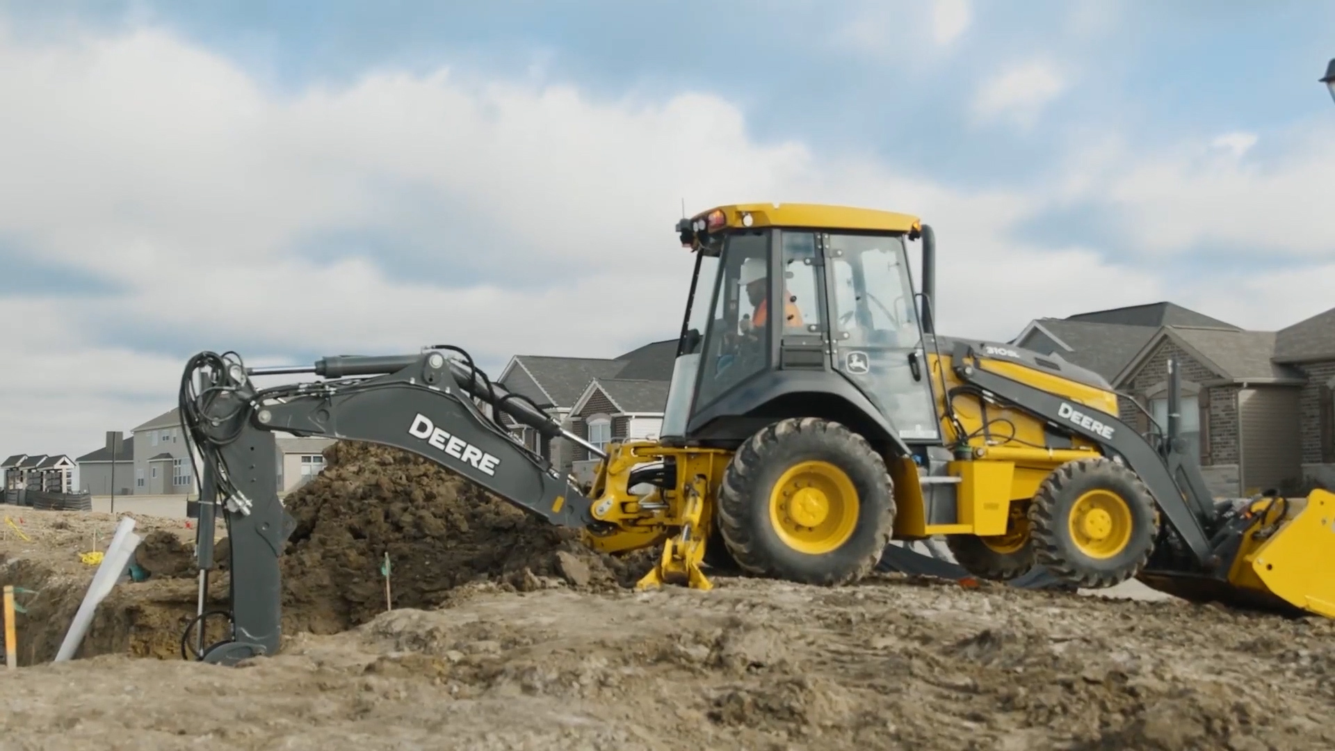 Backhoe performing excavation work on a development site