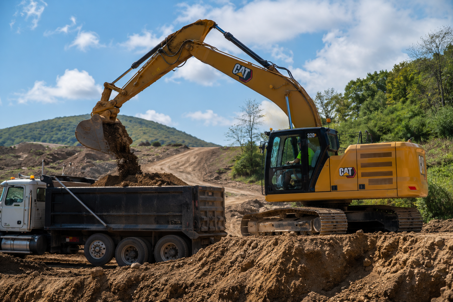 Excavator loading material into a dump truck on an active jobsite