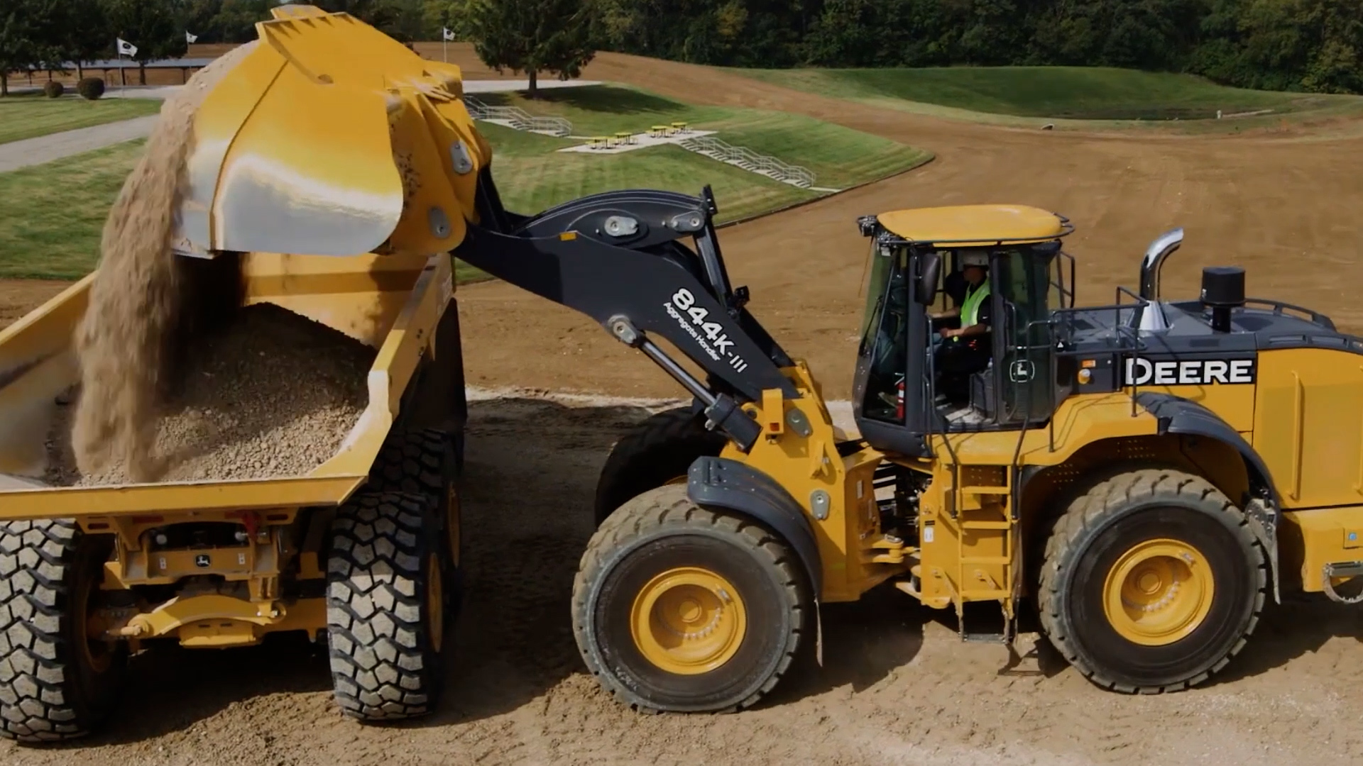 Front-end loader loading material into a haul truck