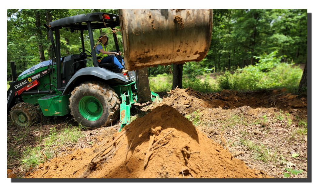 student operating a backhoe